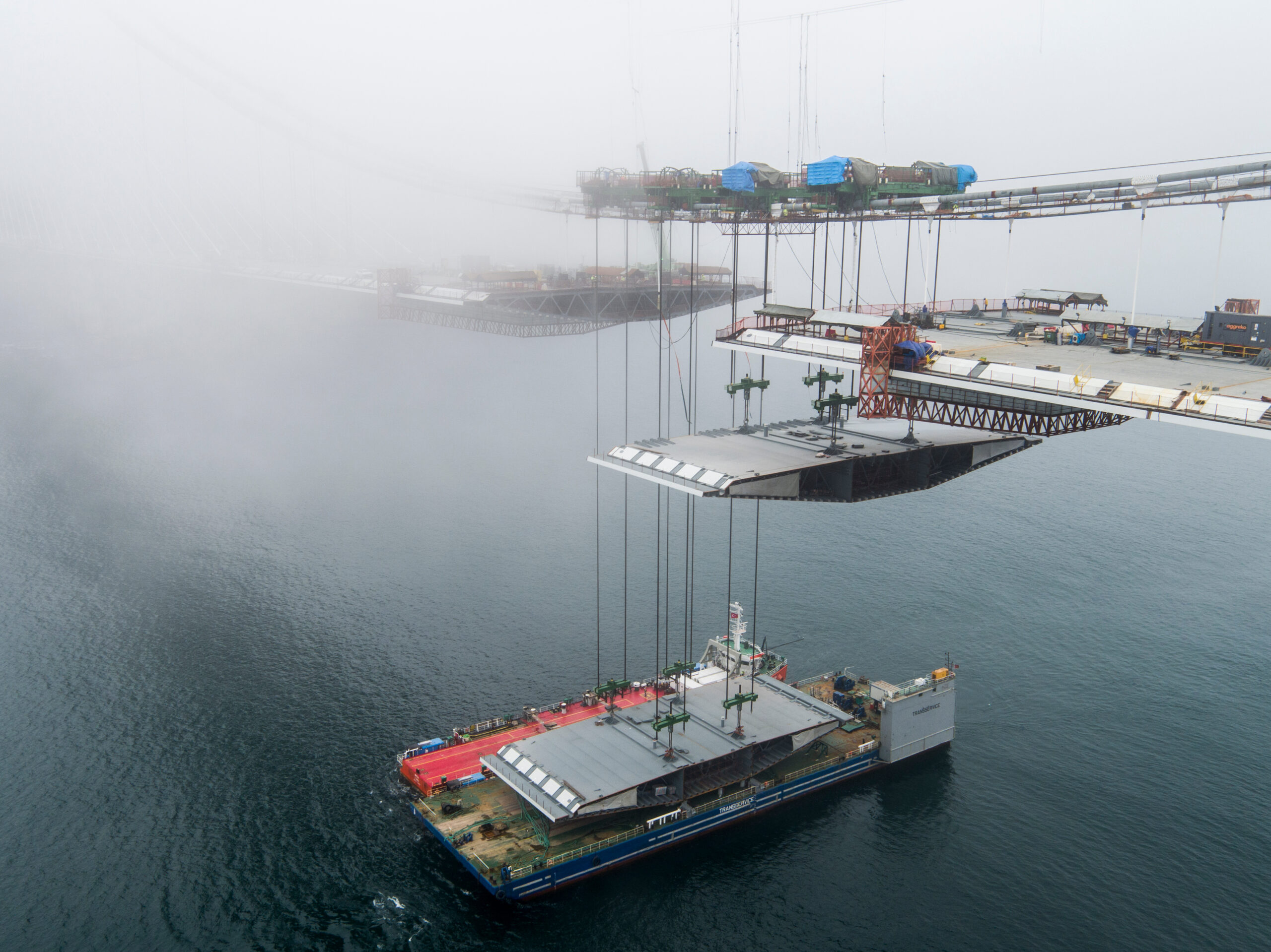 The last decks are being lifted during the construction of the 3rd Bosphorus Bridge in İstanbul, Turkey. The last decks are being lifted simultaneously with the cranes on the main cable.